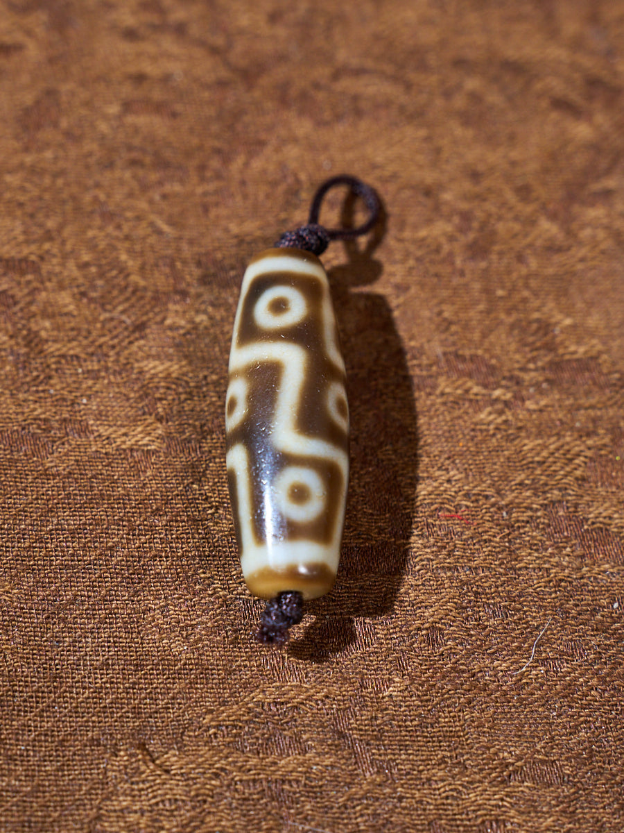 Ninefold Convergence · One-of-a-Kind Nine-Eyed Dzi Bead
