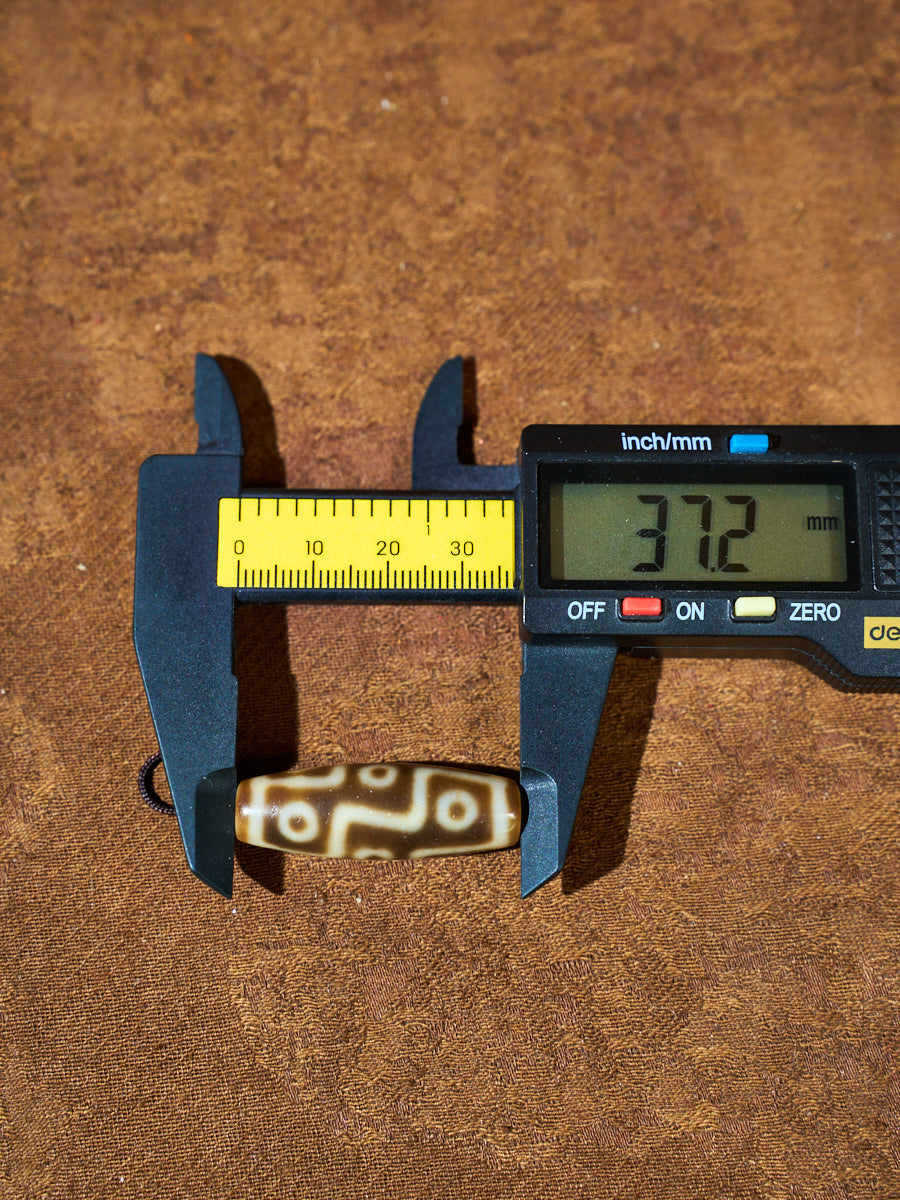 Ninefold Convergence · One-of-a-Kind Nine-Eyed Dzi Bead