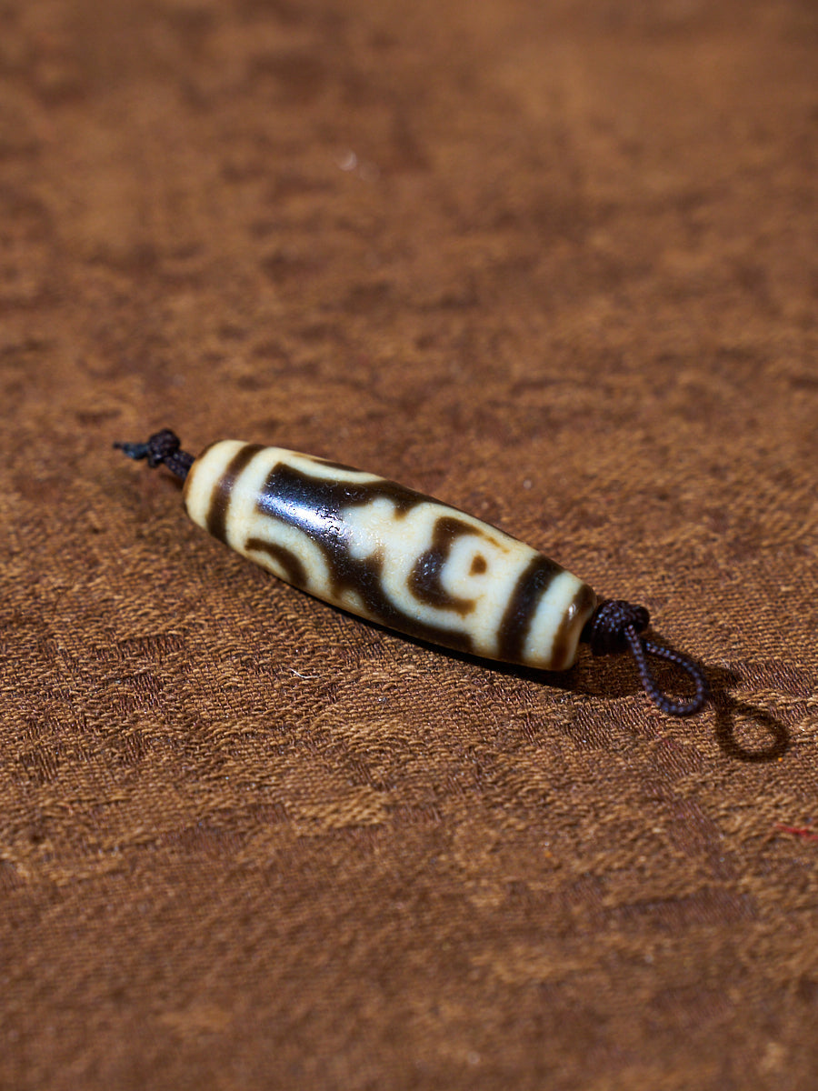 Ninefold Convergence · One-of-a-Kind Nine-Eyed Dzi Bead