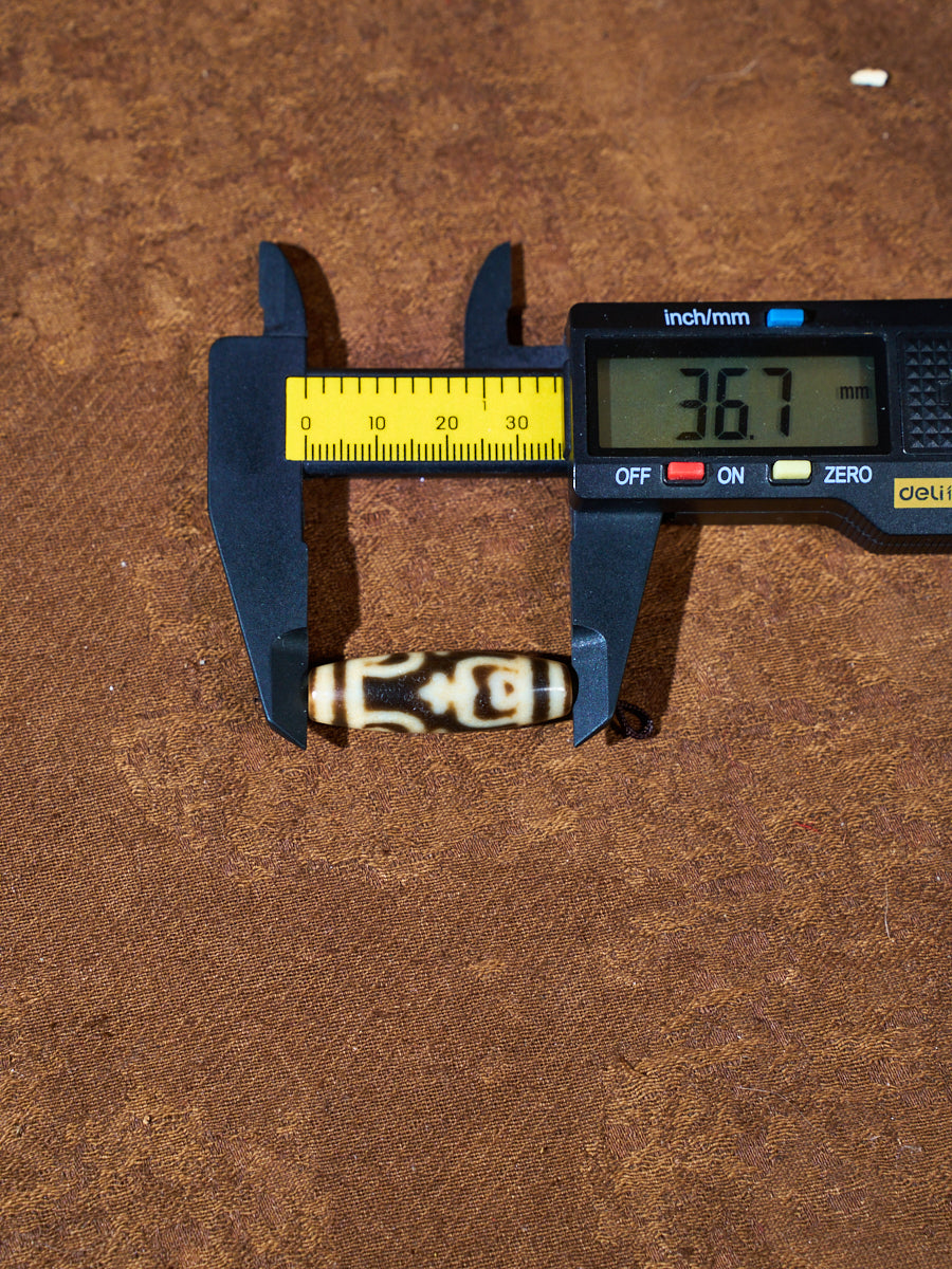 Ninefold Convergence · One-of-a-Kind Nine-Eyed Dzi Bead