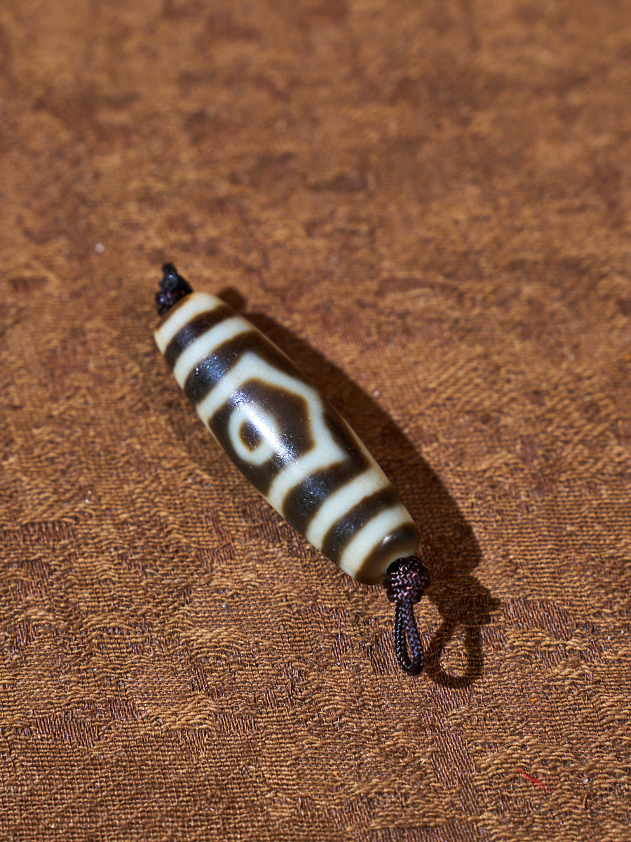 Ninefold Convergence · One-of-a-Kind Nine-Eyed Dzi Bead