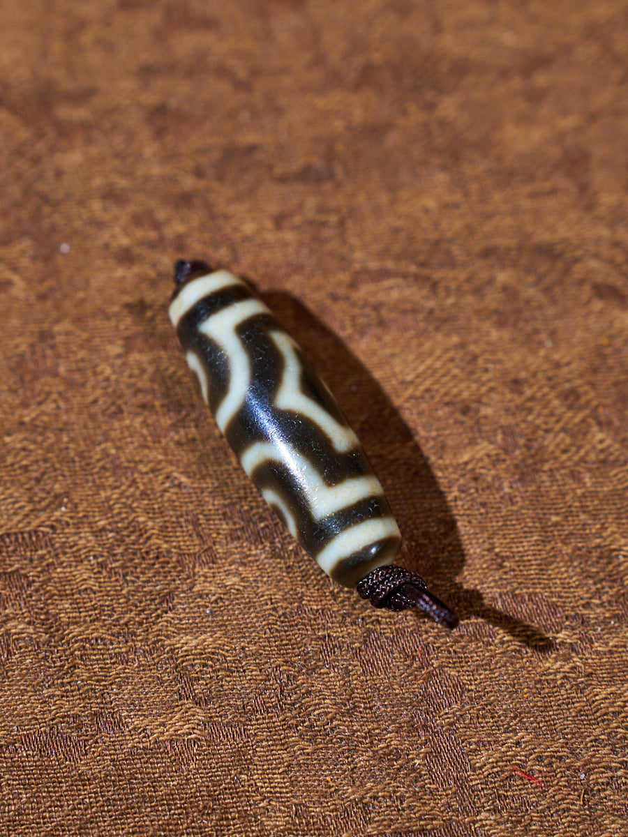 Ninefold Convergence · One-of-a-Kind Nine-Eyed Dzi Bead