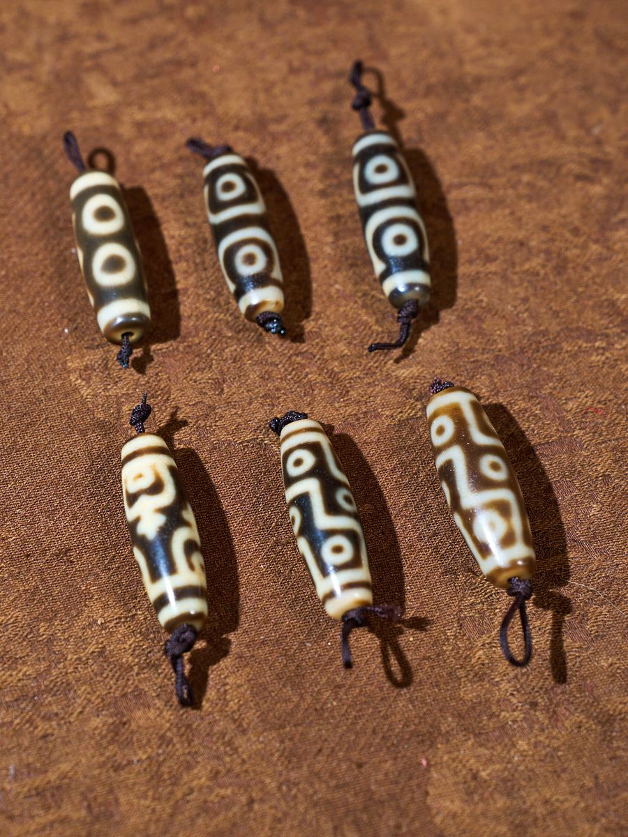Ninefold Convergence · One-of-a-Kind Nine-Eyed Dzi Bead