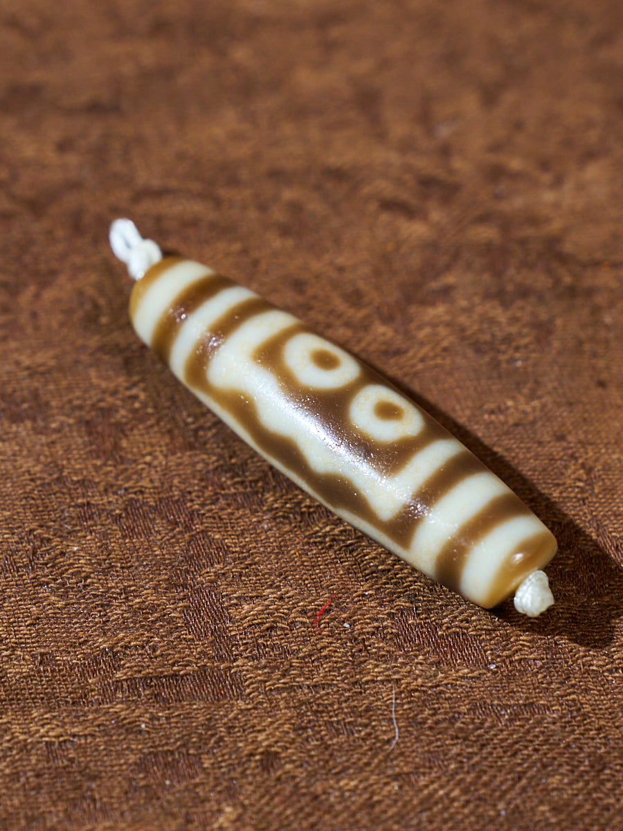 Ninefold Convergence · One-of-a-Kind Nine-Eyed Dzi Bead